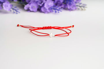 Small cross on simple cord +2 beads 2.5mm